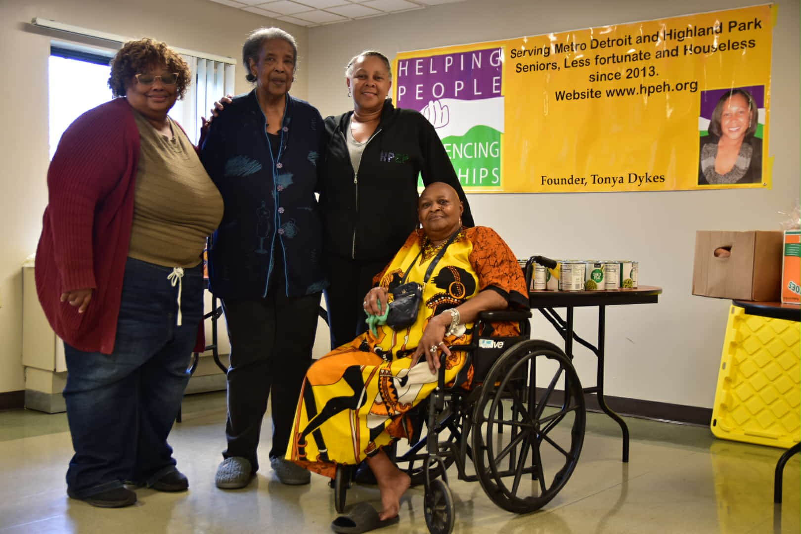 HPEH volunteers gathered together in front of the organization's banner